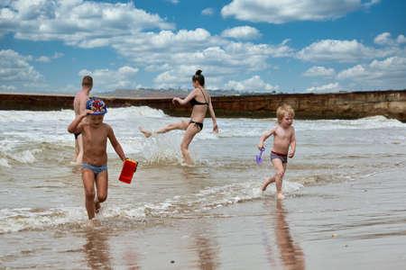Two little boys are playing on the seashoreの写真素材