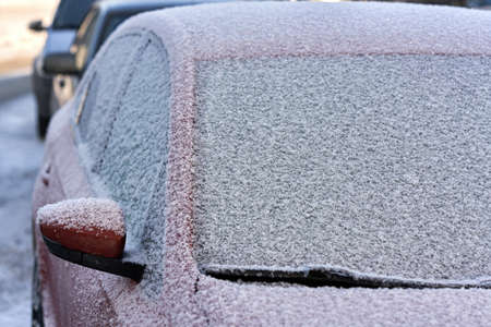 Fragment of the car covered with and snowの写真素材
