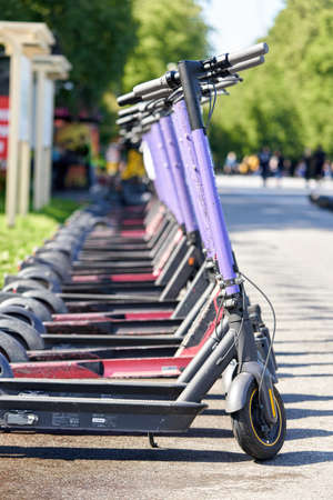 Rental electric scooters in a shared parking lot in the city parkのeditorial素材