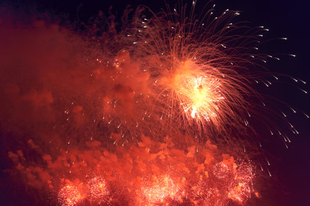 Blurred multicolored fireworks lights against the dark night skyの写真素材