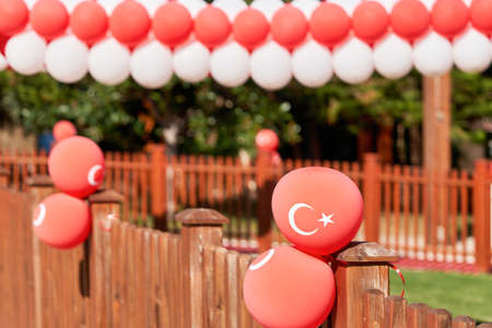 Red balloons with the emblem of the flag of Turkey decorate the streetの写真素材