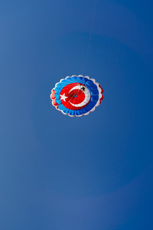 Parachute with the flag of turkey against the blue skyの写真素材
