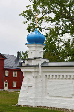 Fragment of the bell tower of a Christian church with a blue roofの写真素材