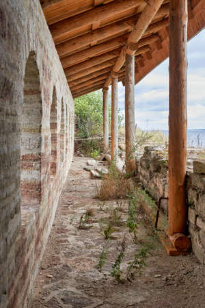Fragment of the old fortress wall with windows overlooking the sea coastの写真素材