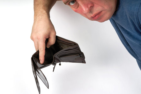 Man holding open empty wallet, poverty and bankruptcy concept