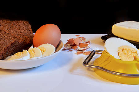 Making a breakfast sandwich, bread and butter and egg with egg cuttingの写真素材