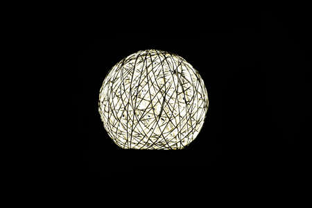 White glowing ball on a black background, the night lamp shines in the darkの写真素材