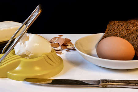 Making a breakfast sandwich, bread and butter and egg with egg cuttingの写真素材