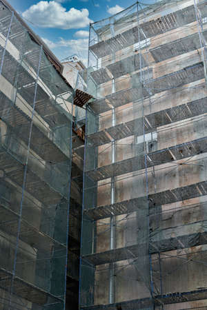 Multi storey residential building in scaffolding, overhaulの写真素材