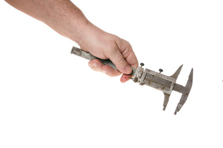 Hand holds an old caliper on a cord on a white backgroundの写真素材