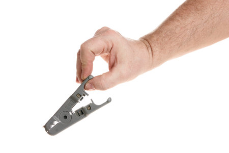 Hand holds a wire stripper on a white background