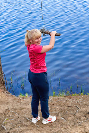 Girl in sportswear prepares for bungee jumping over waterの写真素材