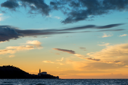 Sunset over Piran, Slovenia  Silhouette of the town Piran with cathedral, view from strunjanのeditorial素材