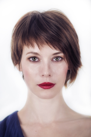 Portrait Of A Young Woman With Short Brown Hair On A White