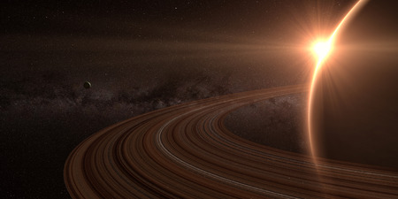 planet saturn with rings at sunrise on the space backgroundの写真素材