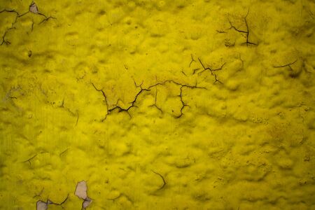 Textured wall with peeling yellow paint. Old building. Beautiful abstract background. Large size photo in good quality.の写真素材