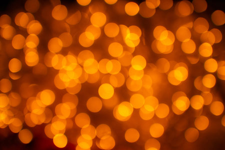 Abstract defocused orange bokeh background. Christmas bokeh lights. Festive glittering blurred...