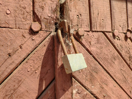 Old closed lock on a wooden door. High quality photo