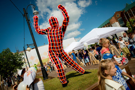 Klin, Russia July 26 2014. City holiday - carnaval. Dancing man in a black and red suit. Editorial...
