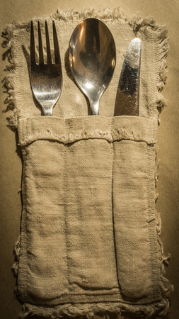 Knife, spoon and fork are in sackcloth pocketの写真素材