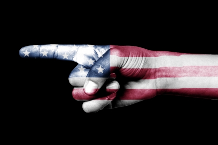 Human hand point with finger in United States of America national flagの写真素材