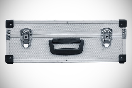 Used aluminum suitcase. Isolated white background.の写真素材