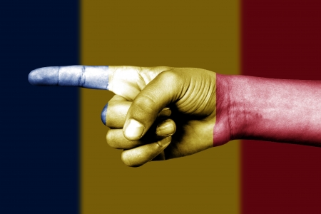 Human hand point with finger in Romania national flagの写真素材