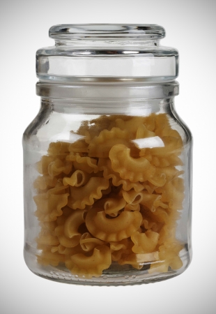 closed jar with raw pasta   isolated on white backgroundの写真素材