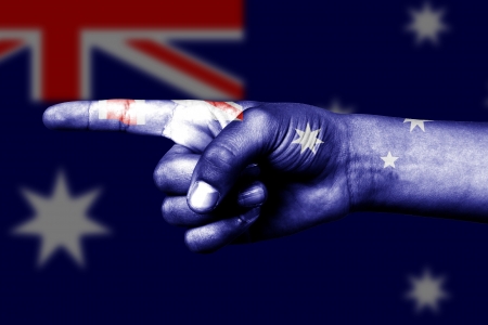 Human hand point with finger in Australia national flagの写真素材