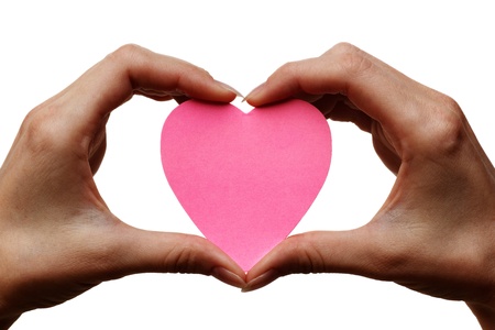 two hands holding pink heart symbol  isolated on white backgroundの写真素材