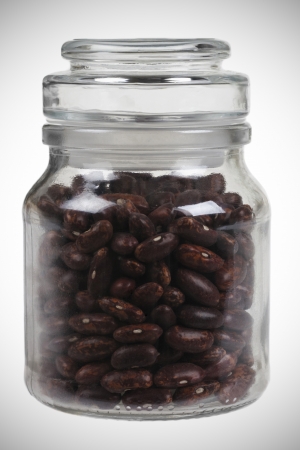 Glass jas of brown beans  isolated on white backgroundの写真素材