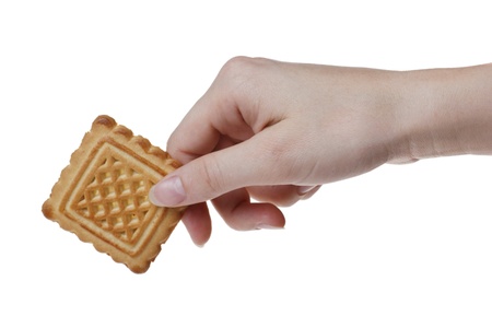 a tasty cookie in woman's hand. Isolated on white backgroundの写真素材