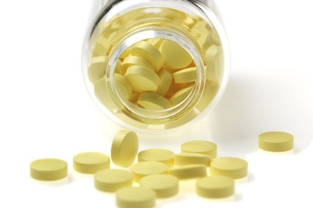 Tablets with jar isolated on white backgroundの写真素材