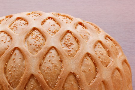 Wheat bread with sesame and pattern. Closup on wooden tableの写真素材