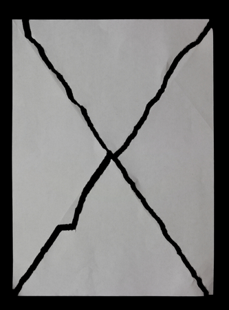 Diagonally torn sheet of paper. isolated on black backgroundの写真素材