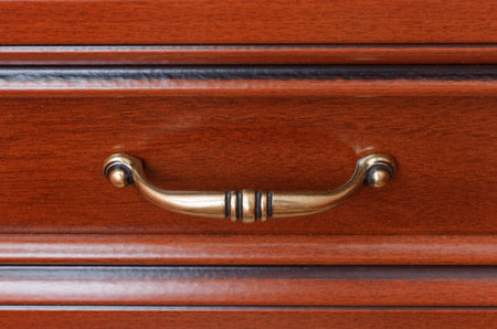 closeup of wooden drawer's handleの写真素材