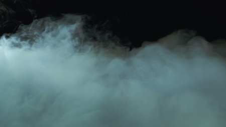 Photo of Realistic Clouds, Smoke, Dry Ice Smoke Texture on black dark Background. For website background, print wallpapers, office or design element, posters and more.の写真素材
