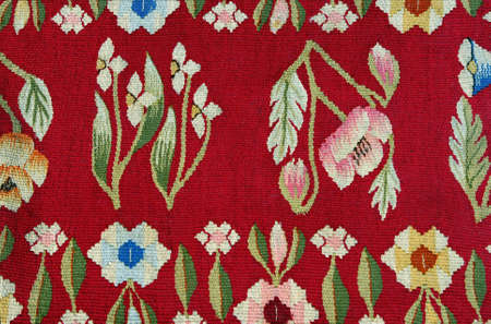 Closeup of retro carpet fabric pattern with multi-colored  floral ornament.の写真素材