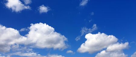 Several clouds in the blue sky in sunshineの写真素材