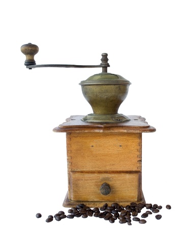Ancient coffee grinder and the coffee grains isolated on the whiteの写真素材