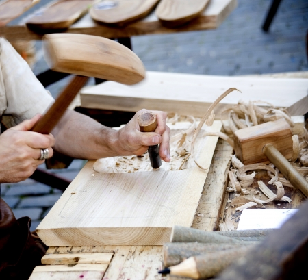 The joiner does a dimple in a board, working with a chisel の写真素材