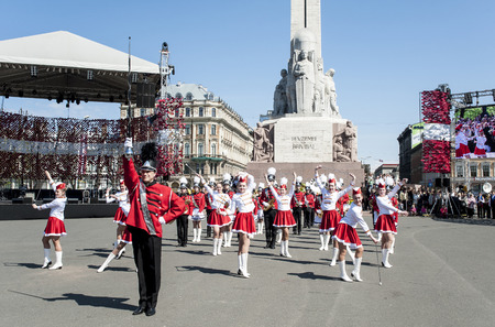 Riga, Latvia - May 4, 2016: Day of restoration of independence of Latvia. Performance of children's brass bands of Latvia (fashion show) at Freedom monument.のeditorial素材