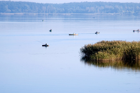 Landscape. Morning fishing from the boat on the lake during a calm.の写真素材