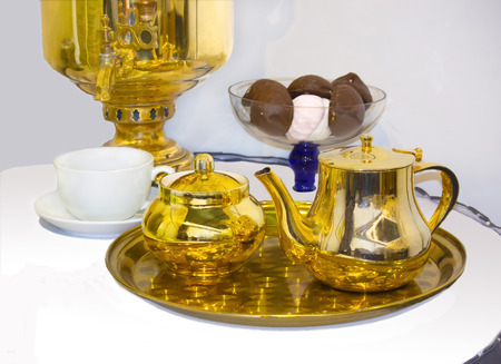 Russian vintage tea set: samovar, teapot, sugar bowl, cup and sweet.の写真素材