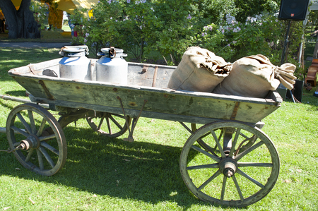 Village. The cart with cans of milk and bags with potatoの写真素材