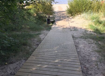 Latvia, Jurmala. Wooden path leading through the dune to the seaの写真素材