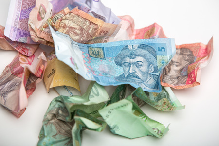 Bruising Ukrainian currency, the hryvnia on a white background.の写真素材