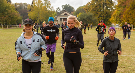 Kyiv, Ukraine - October 08/2016. Outdoor CrossFit training, preparation for competition "Race Nation." Autumn. Girls perform jogging at morning training CrossFit.のeditorial素材