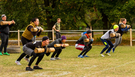 Kyiv, Ukraine - October 08/2016. Outdoor CrossFit training, preparation for competition "Race Nation." Autumn. Participants  training perform long jump with a log on his hands.のeditorial素材