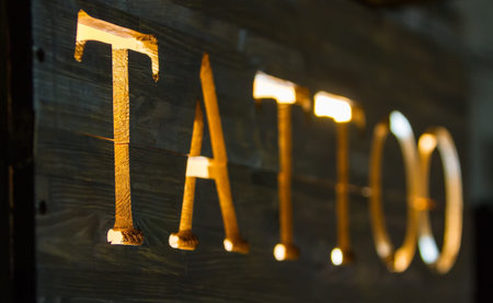 luminous wooden signboard with the word tattooの写真素材